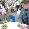 thumbnail of police officer and grade school student