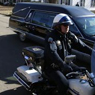photo of cop riding next to hearse