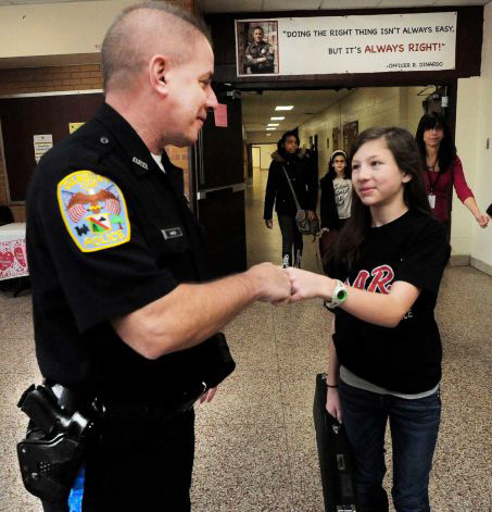 photo of SRO and student giving a fist bump