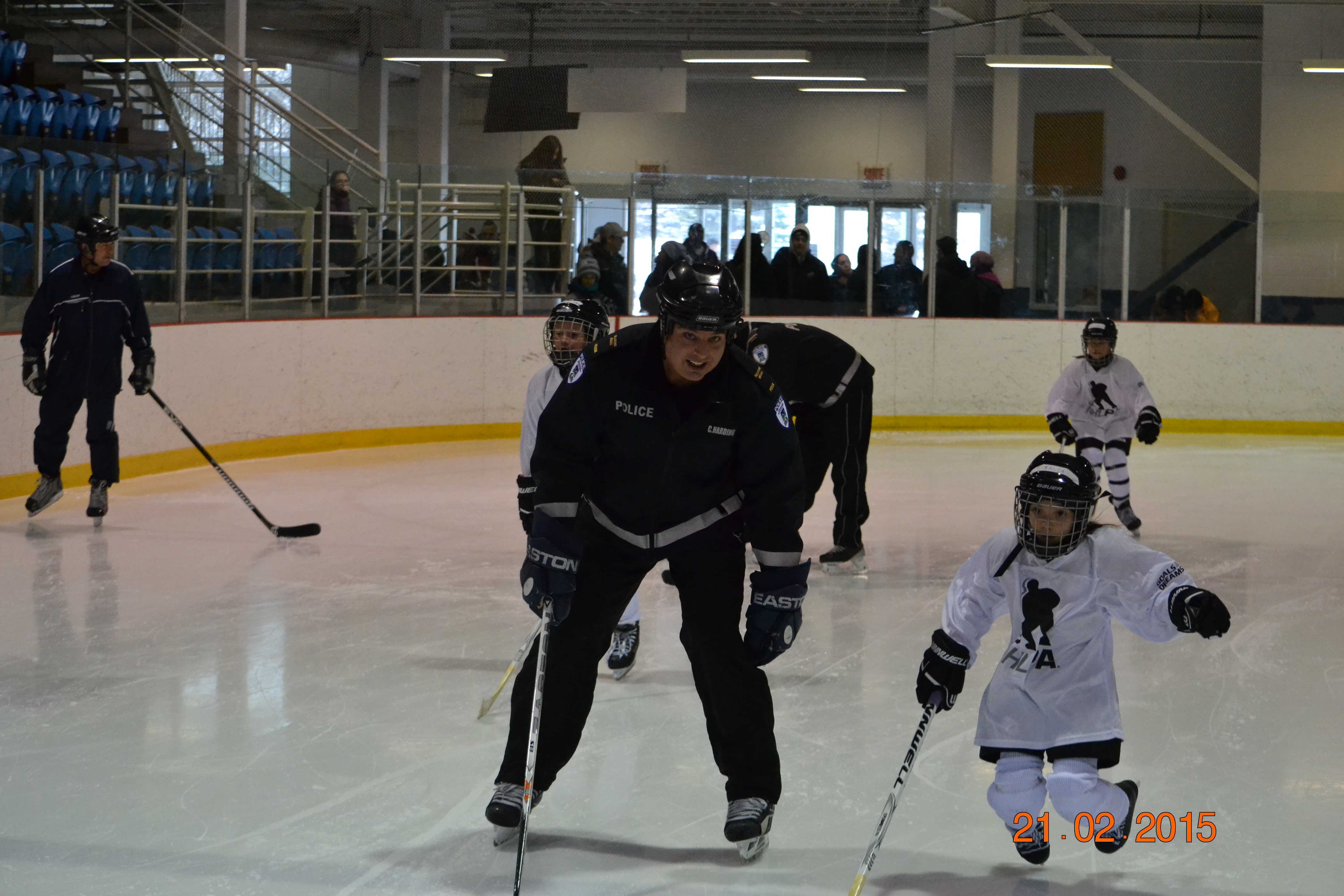 Tournament and Ville Deux-Montagnes Officer Chris Harding teaching a child to skate as part of the Les Forces police hockey program
