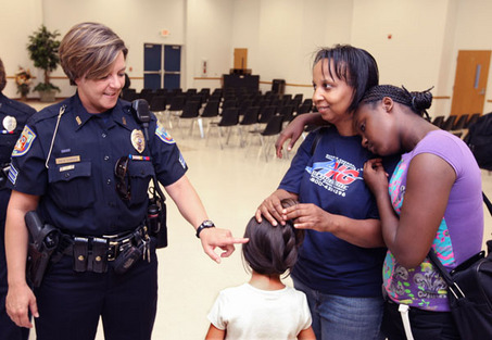 Kalamazoo Department of Public Safety Officer Julie Yunker with a mother and her daughters