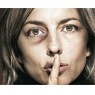photo of a woman with a black eye and a finger over her lips