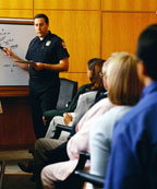 Police Officer speaking and demonstrating at a meeting