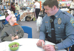 Police officer with grade school student