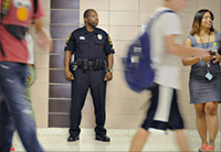 A School Resource Officer in a high school hallway