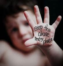 photo of a child holding showing their palm that has written on it stop the abuse pretty please