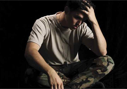 photo of soldier with hand on his head in grief