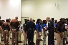 An Achievable Dream Middle and High School students greet and shake hands with Newport News Sheriff's Office deputies and Newport News Police Department officers, as they do every morning before school begins